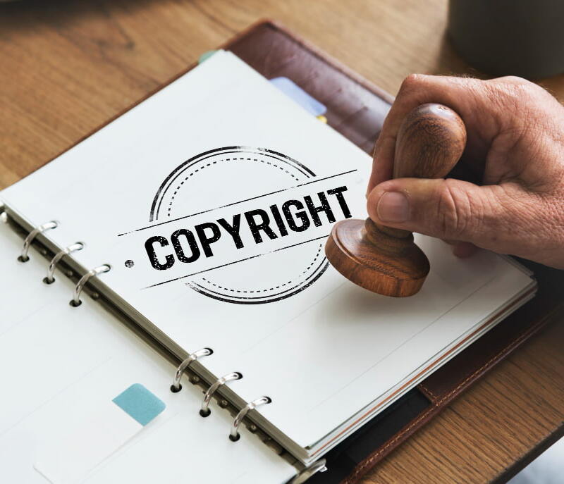 Illustration of copyright symbols and a lock symbolizing protection - Websmartify